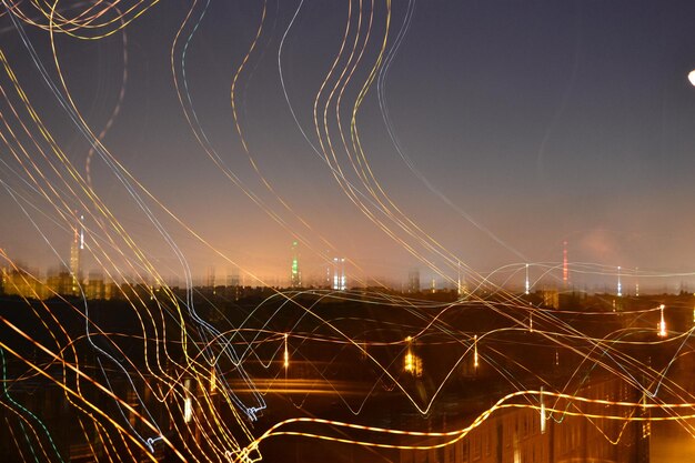 A visualization of a smart grid, with lines representing energy flow between renewable energy sources, buildings with smart meters, and the central grid control system.