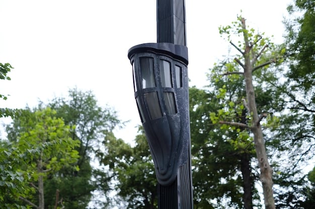 A close-up shot of a smart street light pole in a US city, equipped with sensors, cameras, and charging ports for electric vehicles. The scene includes pedestrians walking by and showcases the integration of technology into everyday urban infrastructure.