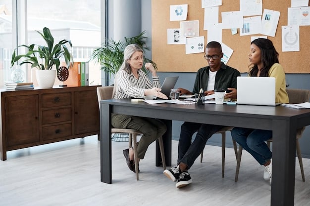 A diverse group of professionals of different ages and ethnicities collaborating on a project around a table in a bright, modern office.