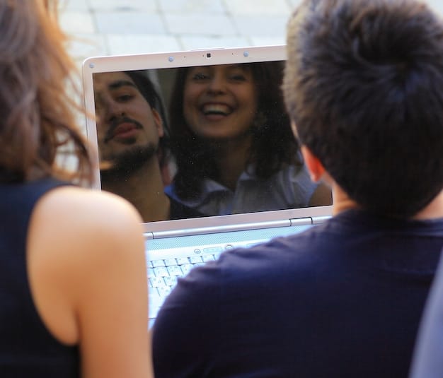 An image capturing a virtual community event in progress. People are shown on their computer screens participating in the event, with cheerful expressions. The event banner indicates it's a local community meeting held online.