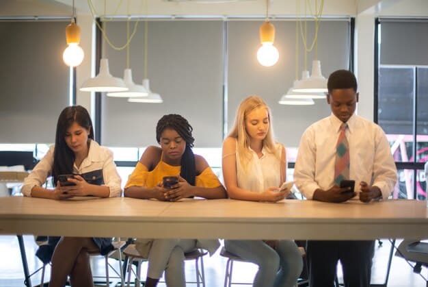 A group of business professionals from different ethnic backgrounds collaborating around a table in a modern office space. The image should focus on teamwork, diversity, and a shared sense of purpose.