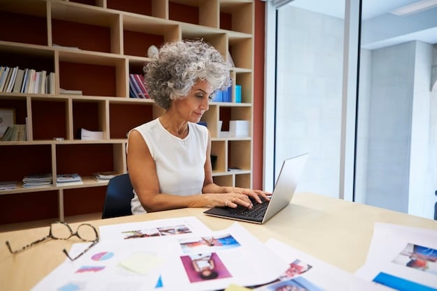 A senior woman using a laptop in a co-working space, working on a project, illustrating the concept of encore careers and active engagement in the workforce during retirement.