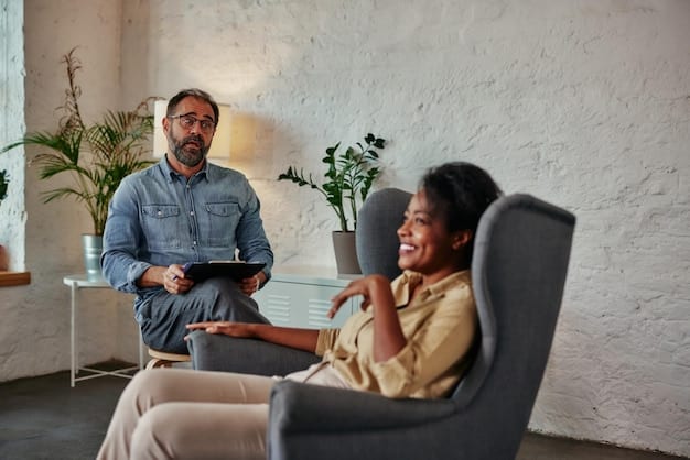 A mental health professional sitting across from a client, both smiling. The setting is a cozy office, and the professional is actively listening. The image reflects a welcoming and supportive therapeutic environment.