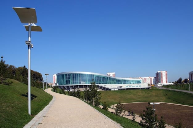 Solar panels on the roof of a hospital in a sunny, green environment, symbolizing sustainable and resilient healthcare infrastructure.
