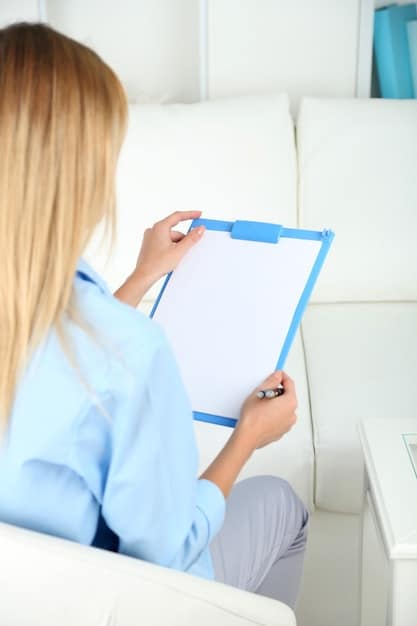 A close-up of a doctor's hand holding a prescription pad with a prescription for buprenorphine, used for medication-assisted treatment (MAT), against a blurred background of a clinic setting.