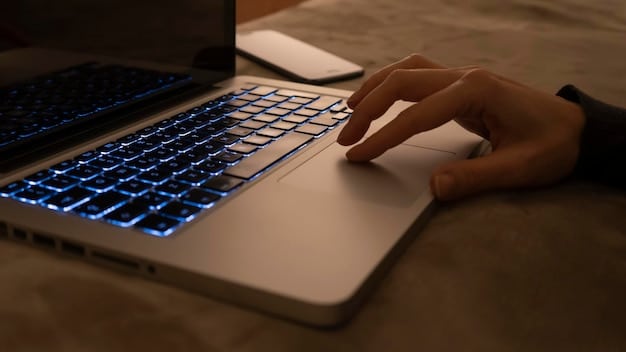 A close-up shot of a person's hands typing on a laptop, with code visible on the screen. The focus is on the keyboard and the illuminated display, symbolizing digital literacy and technical skills.
