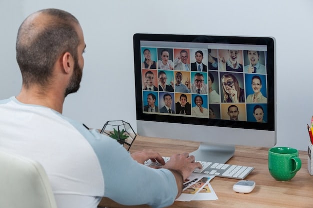 A person participating in a virtual meeting, with a diverse group of colleagues displayed on the screen. The setting is a home office, with books and personal items visible in the background, highlighting digital communication and remote collaboration.