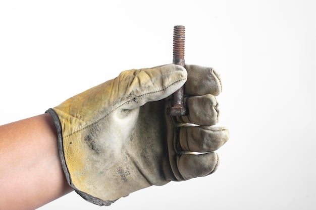 A detailed close-up of a construction worker's gloved hand tightening a bolt on a newly installed bridge beam. The shot focuses on the precision and care involved in infrastructure development. The background shows the partially constructed bridge with other workers and equipment in the distance, emphasizing the collaborative effort and advanced technology used in the project.