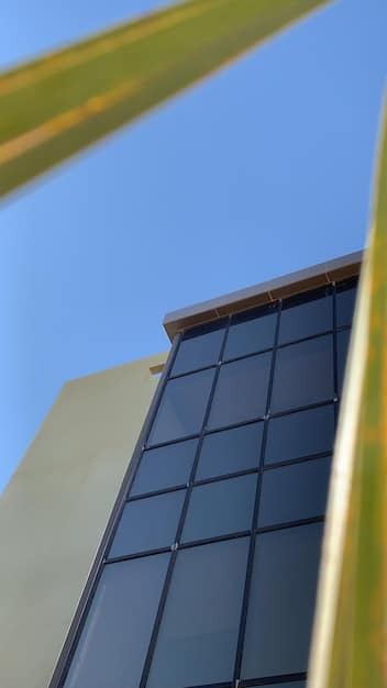 A close-up shot of a solar panel installation on a commercial building roof, with the sun reflecting off the panels. The image should convey a sense of clean energy and technological advancement.